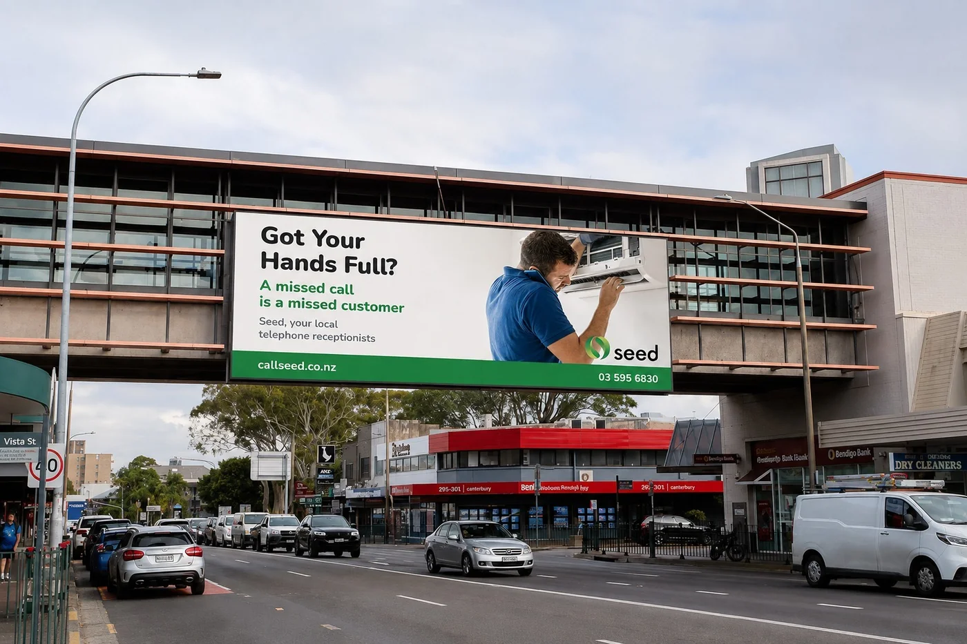Seed billboard over a Sydney street reading Got Your Hands Full? A missed call is a missed customer. Seed, your local telephone receptionists