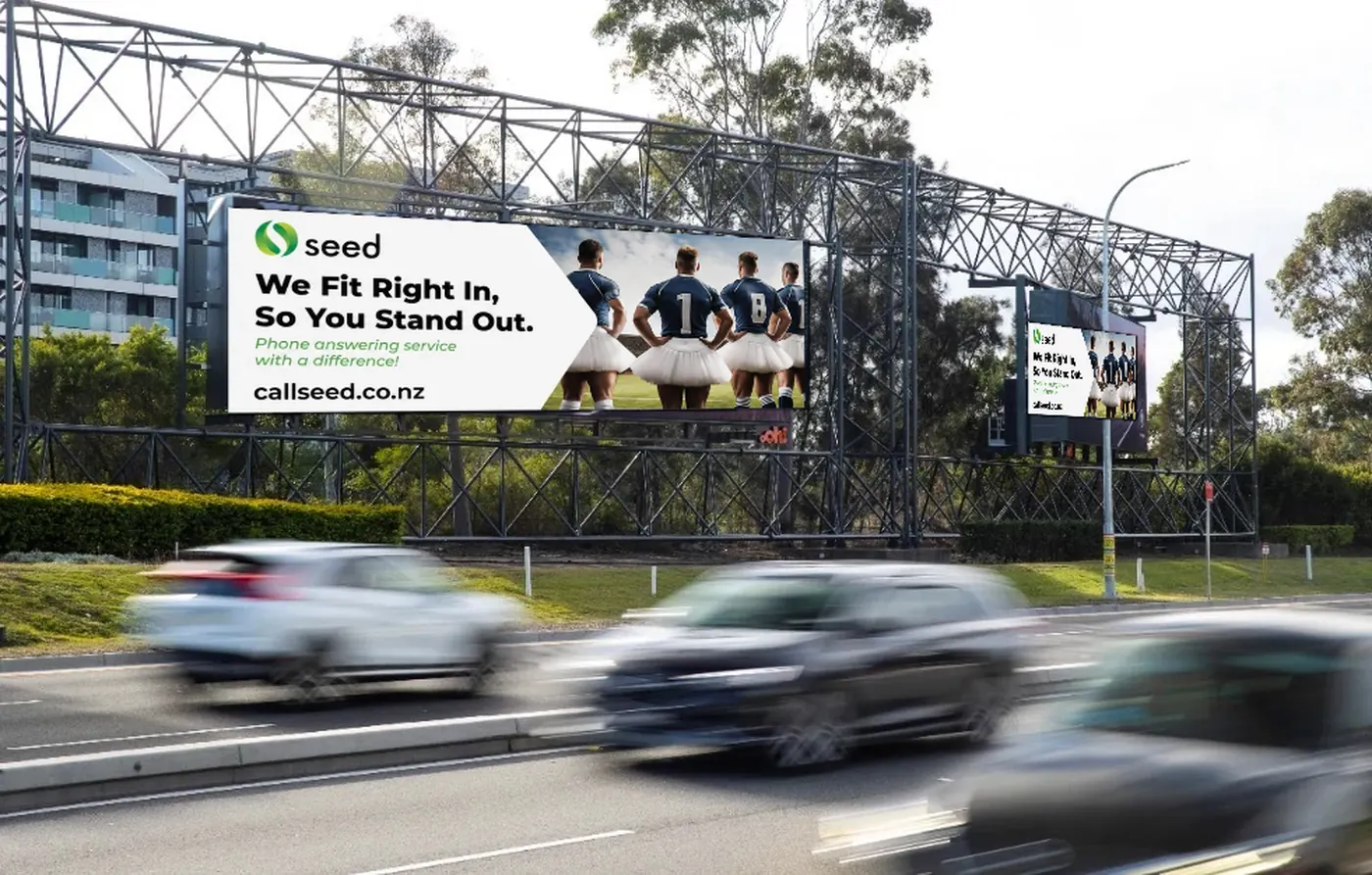 Seed billboard on a Sydney arterial road reading We Fit Right In, So You Stand Out