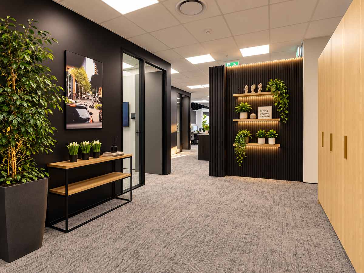 Office foyer with a black feature wall, timber shelves and plants