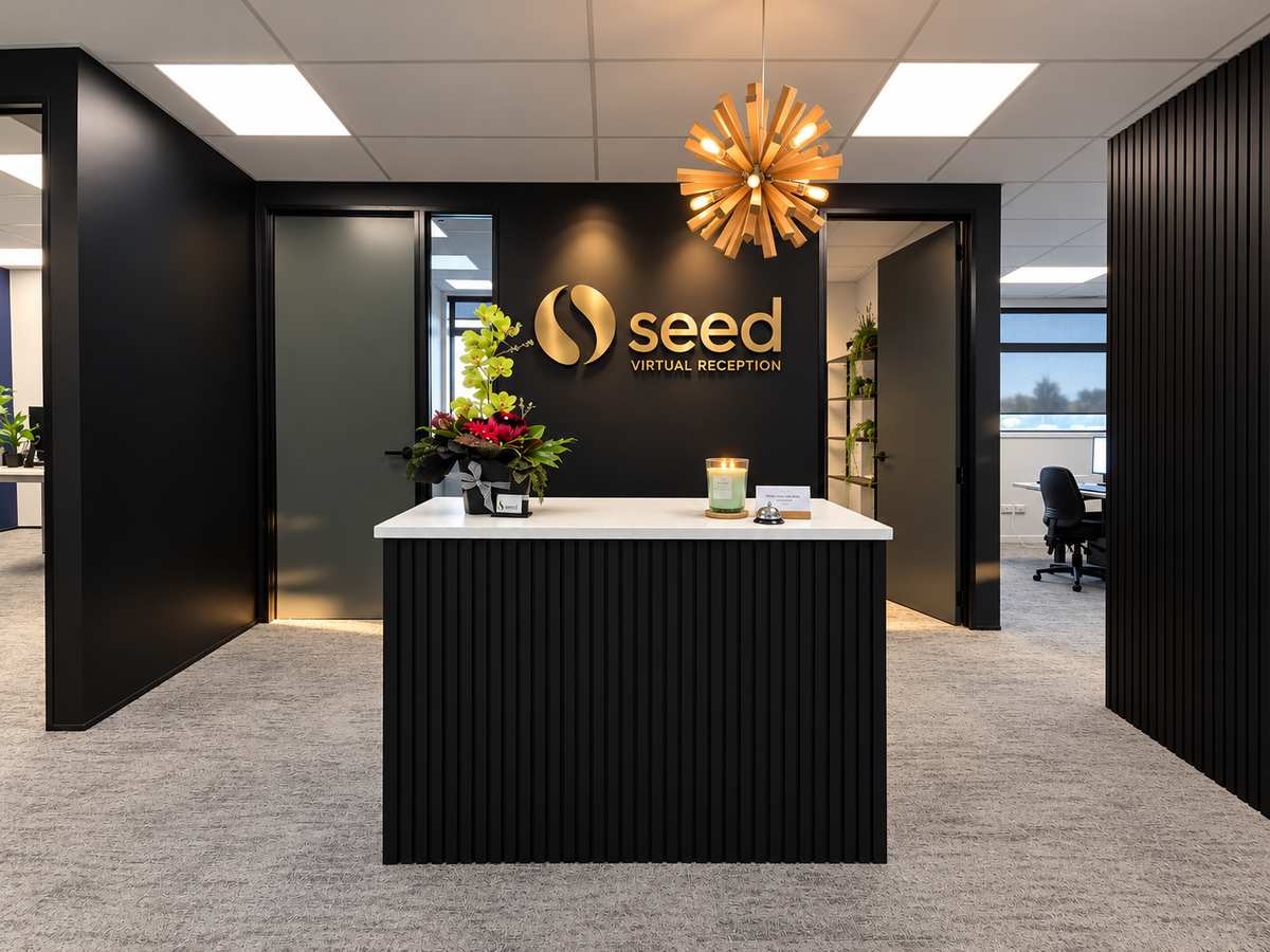 Seed reception desk with the Seed Virtual Reception sign behind it